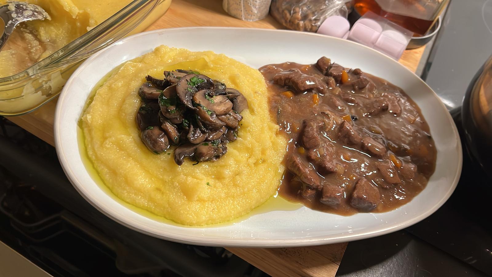 Creamy polenta with sautéed mushrooms and slow-cooked beef stew — comfort Italian cooking Amsterdam